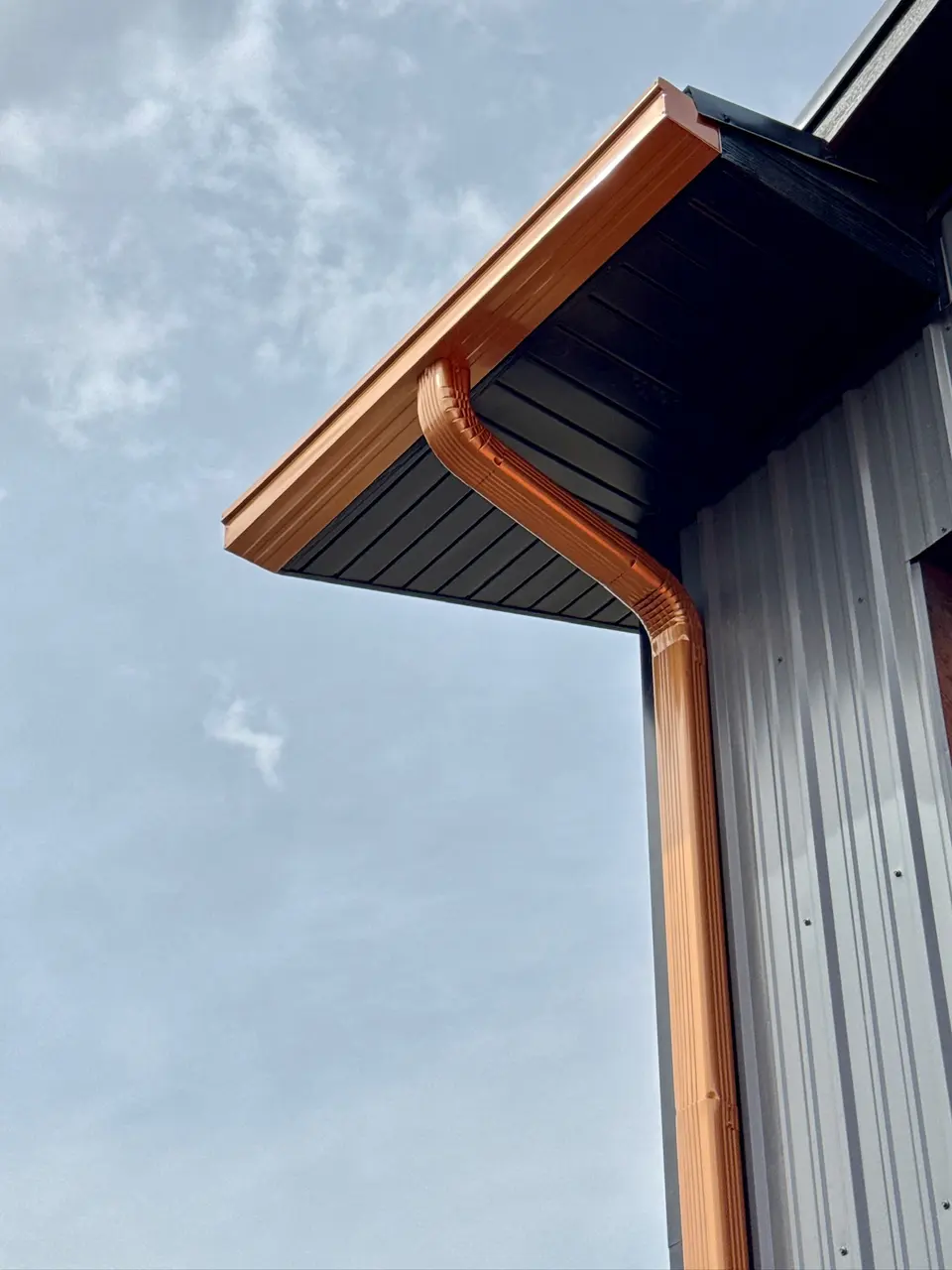 Aerial view of the crew installing gutters along a roofline