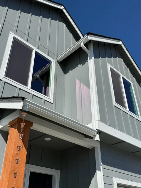 New seamless gutters on a board and batten home