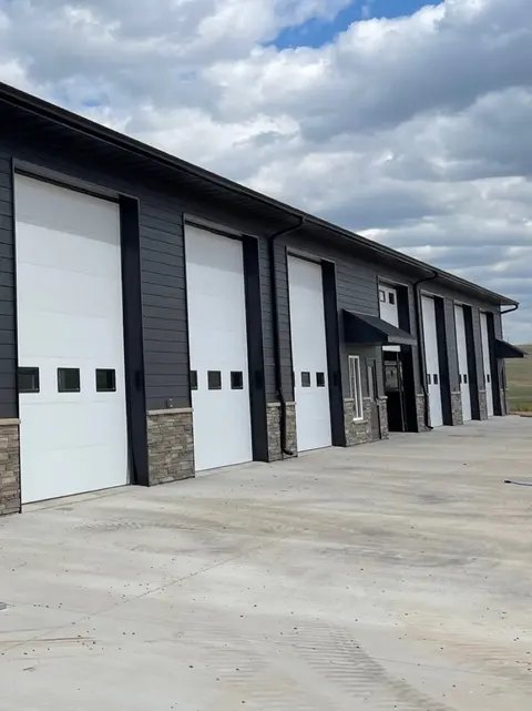 Gutters and downspouts on a white commercial building