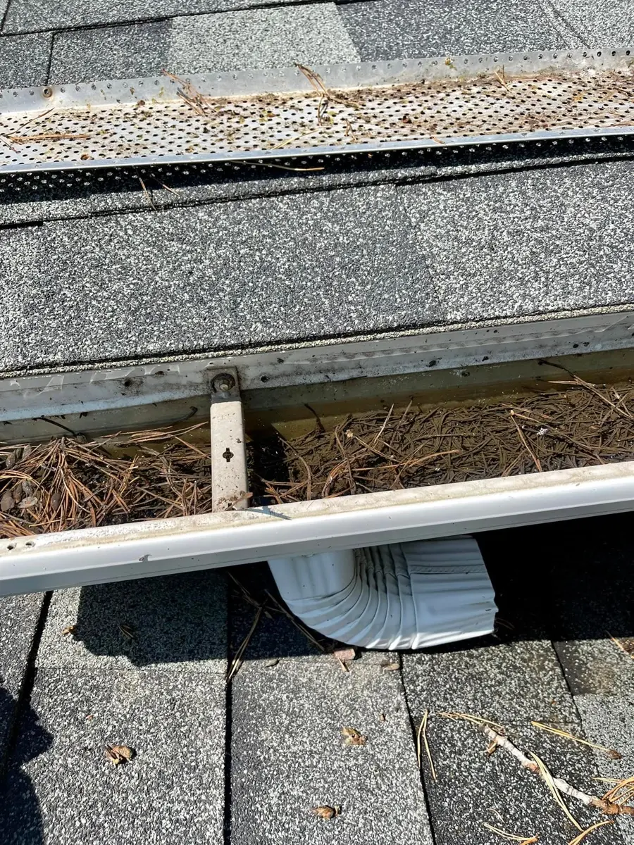 Water overflowing the front edge of a residential gutter