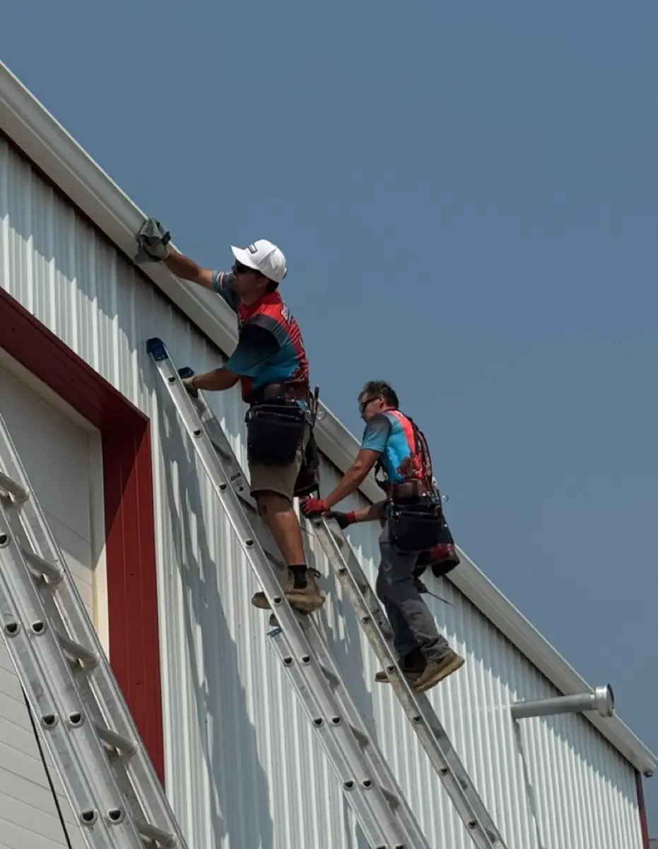 Technician servicing a gutter run on a residential home