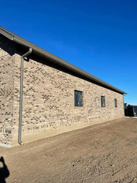 Seamless gutters on a stone-faced commercial building