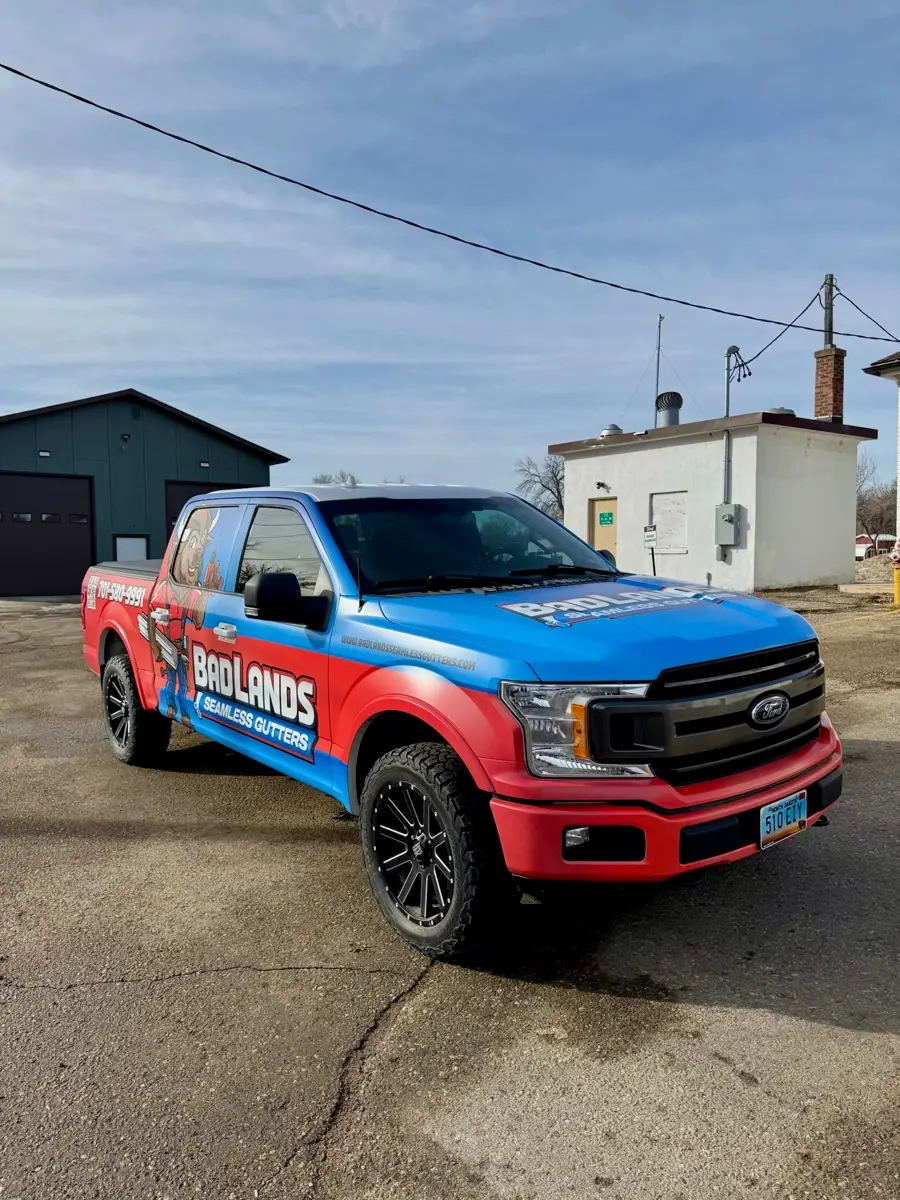Wrapped Badlands Seamless Gutters pickup outside the shop